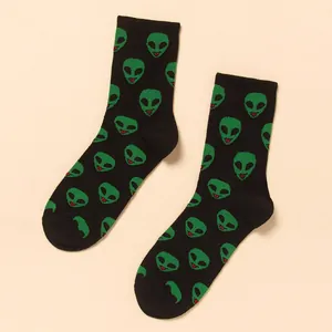 Trendy black mid-calf crew socks featuring a vibrant green alien head pattern for men.