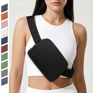 Detail showing a black waterproof nylon crossbody chest bag on a female athlete
