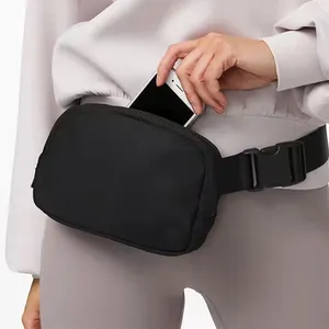 Waterproof black nylon waist bag with adjustable strap for outdoor sports and running.