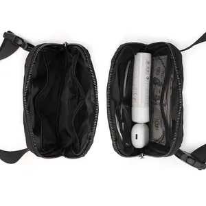 Internal view of black nylon waist bag showing multiple compartments and storage capacity