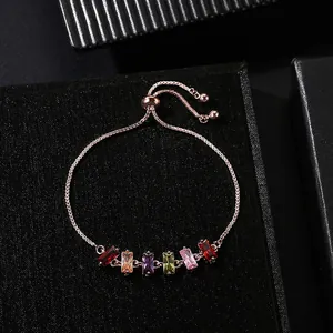Close-up of adjustable rose gold bracelet with colorful rectangular cubic zirconia