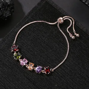 Detailed close-up of adjustable rose gold bracelet featuring vibrant oval zircon stones