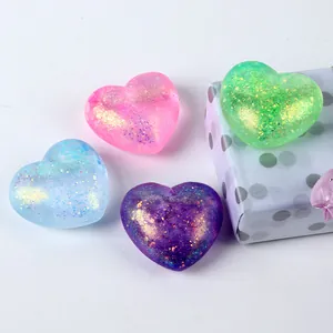 Vibrant glitter heart-shaped stress relief squeezy toys in four bright colors