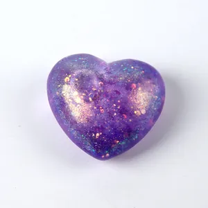 Macro detail of a purple glitter heart-shaped squishy toy with slow rebound effect