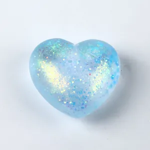 Detail shot of a blue heart-shaped squishy toy with sparkling glitter interior
