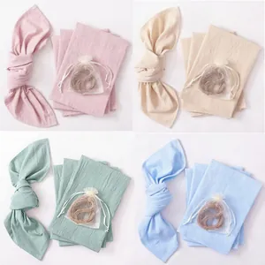 Set of cotton linen table napkins in four soft colors for festive party decorations