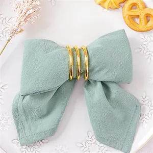 Sage green bow-knot napkin with golden rings for elegant holiday table decor