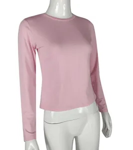 Slim-fit pink long-sleeved T-shirt with round neck displayed on a female mannequin.
