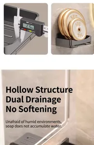 Close-up of wall-mounted soap holder detail showing double drainage and load-bearing test