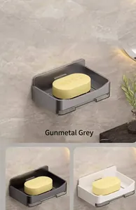 Detail view of wall-mounted soap dishes in gunmetal grey, white, and black