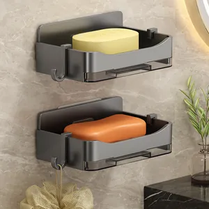Wall-mounted grey soap dishes with drainage tray and hooks in a bathroom setting