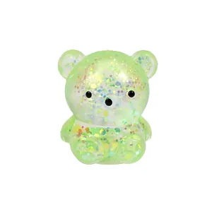 Close-up of a translucent green glitter bear squishy toy for stress relief