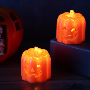 Pair of glowing orange LED pumpkin night lights for festive Halloween table decorations