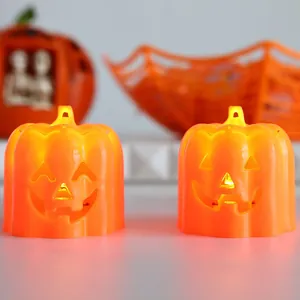 Pair of glowing orange Halloween LED pumpkin night lights with jack-o'-lantern faces