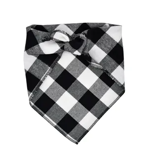 Macro view showing the soft fabric texture and fine stitching of the checkered pet bandana