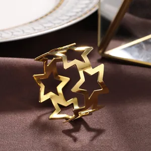 Close-up detail of a golden star-shaped hollow metal napkin ring for table decor