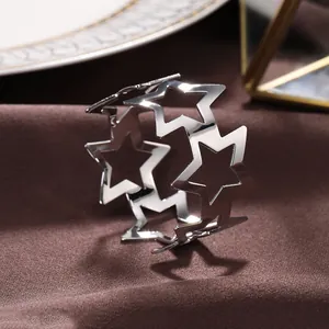 Close-up detail showing the hollow star design of this silver metal napkin ring holder
