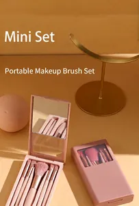 Detailed view of a portable 5-piece makeup brush set in a pink case with a built-in mirror.
