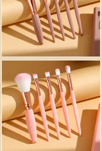 Close-up of pink and rose gold mini makeup brushes with soft dual-color bristles