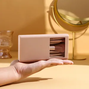 Portable five-piece mini makeup brush set stored in a compact pink mirrored window case