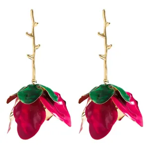 Detailed view of handmade 3D floral earrings with golden branch drop and magenta petals