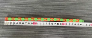 Measurement showing the full length of a 24-section fidget chain toy on a tape measure