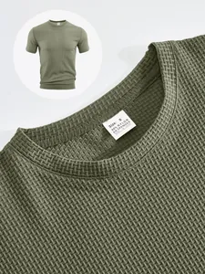 Detail of men's olive green waffle knit T-shirt showing collar tag and texture