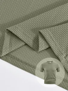 Close-up view of olive green waffle knit fabric and hem stitching on a men's T-shirt