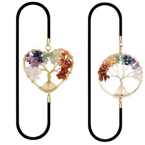 Close-up of heart and round Tree of Life pendants with colorful natural chakra stones