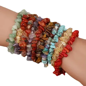 Detailed macro view of colorful natural stone chip bracelets stacked on a female wrist.