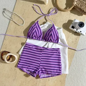 Detail shot of purple striped terry cloth bikini set with summer vacation accessories.