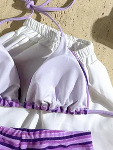 Close-up detail of purple striped terry cloth bikini set showing soft textured fabric
