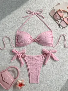 Detailed high-angle view of pink floral textured bikini set with flower buckles.