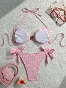 Macro detail view of pink textured floral bikini showing interior lining and care label