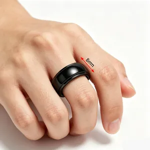 Close-up of 8mm wide black stainless steel spinner ring for men shown on finger