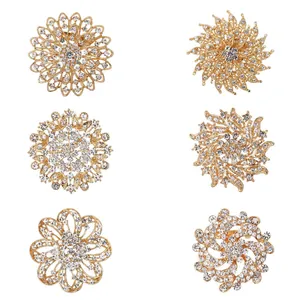Set of six gold-toned crystal flower brooches with sparkling rhinestone details