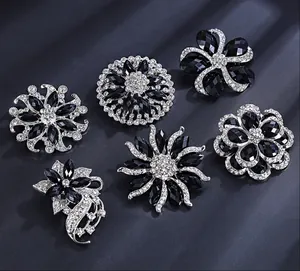Close-up display of vintage black crystal and sparkling rhinestone floral brooches