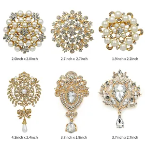 Detailed view of six gold-toned brooches with pearls and rhinestones and dimensions.