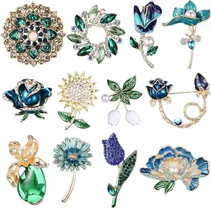 A collection of twelve elegant floral and insect themed brooches with pearls and crystals