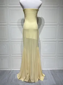 Back view of a pale yellow strapless mesh maxi dress displayed on a white mannequin torso