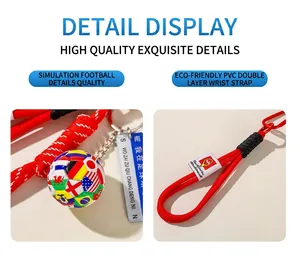 Detailed view of a soccer ball keychain with world flags and a red PVC hand strap.