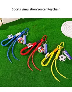 Detailed view of colorful woven rope football keychains on green turf background