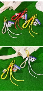 Soccer themed woven rope keychains shown as bag charms on artificial green grass