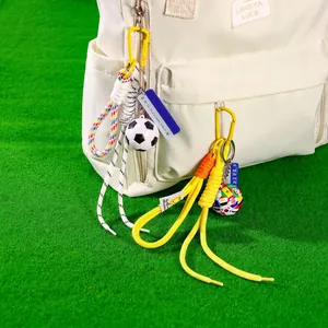 Creative football keychain with World Cup theme charms on a white sports backpack