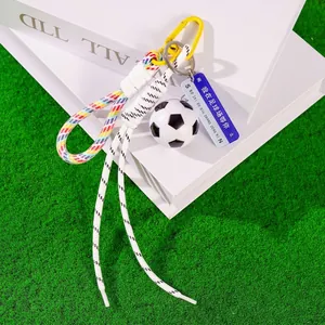 Creative soccer ball keychain with colorful braided rope and blue decorative tag