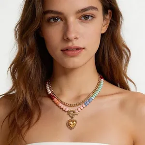 Detailed view of a Bohemian colorful natural stone beaded necklace with golden heart pendant