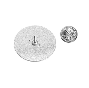 Close-up detailed view of the circular metal pin back with a silver butterfly clutch fastener