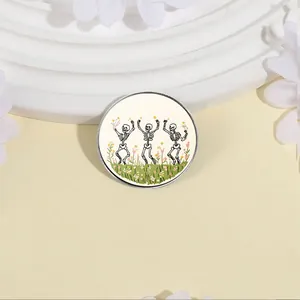Close-up of a vintage pastoral brooch with three dancing skeletons in a flower field.