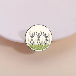 Vintage dark aesthetic dancing skeletons brooch with colorful floral detail and beige base