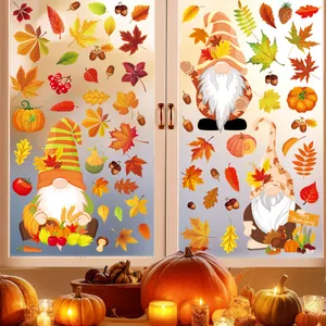 Detail of Thanksgiving window clings with cartoon gnomes and maple leaves on frosted glass.